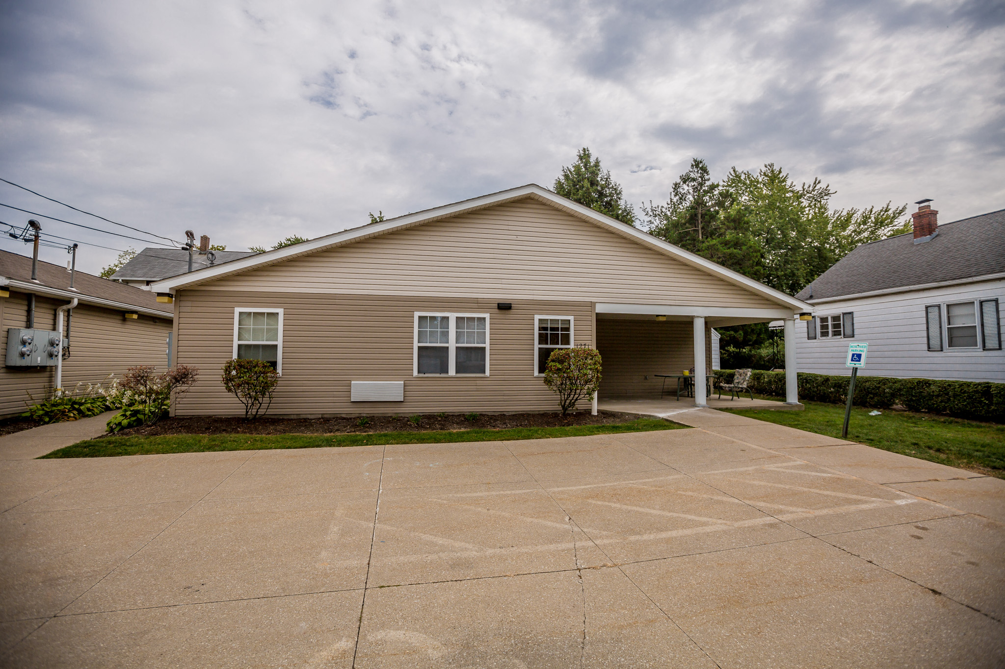 a tan house with a driveway in front of it